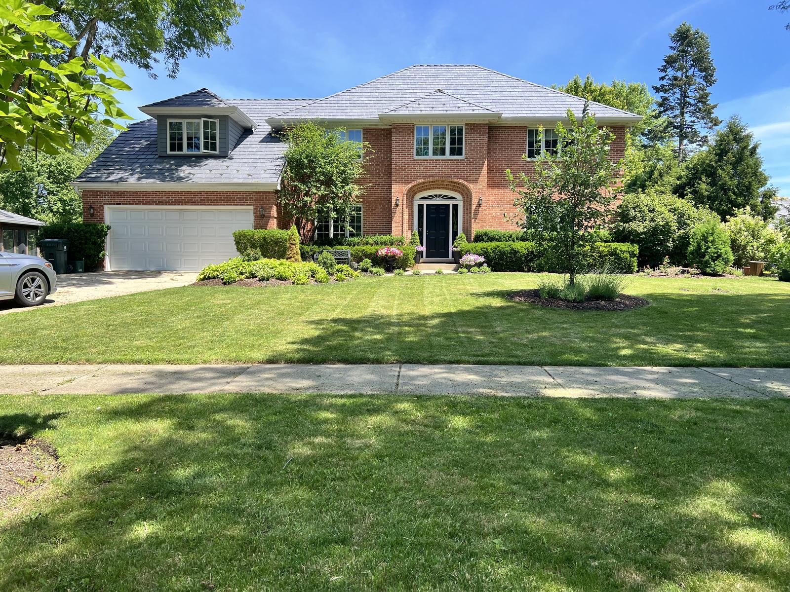 Brick colonial with manicured landscape